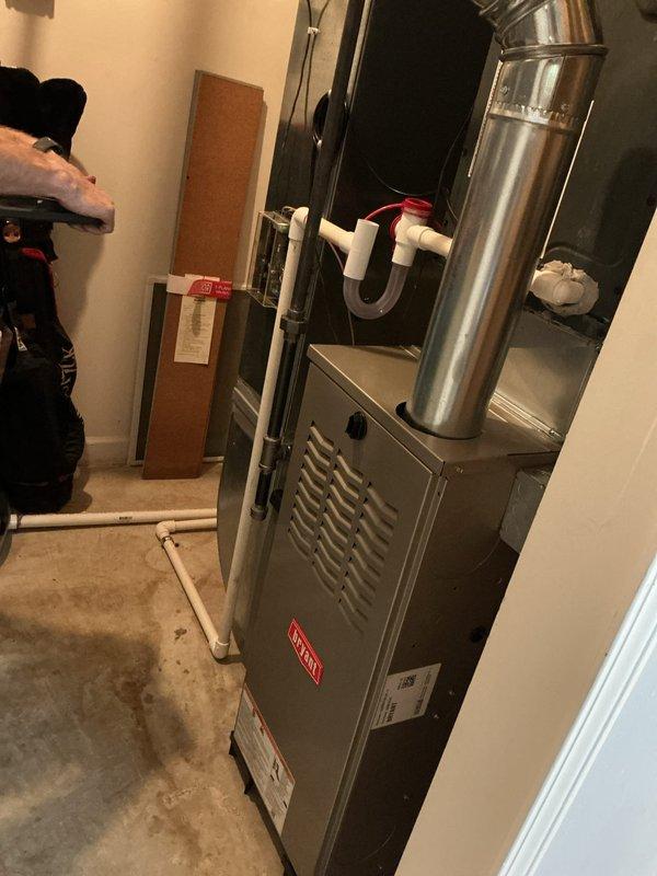 Completed installation of Bryant residential gas furnace system in basement utility area. Installed new furnace unit with proper venting configuration, including metallic exhaust pipe and white PVC condensate drain system with trap assembly. Routed all necessary piping and ductwork connections to integrate with existing HVAC infrastructure. Verified proper clearances, secured all connections, and ensured system meets manufacturer specifications and local building codes. Unit tested and operational upon completion.