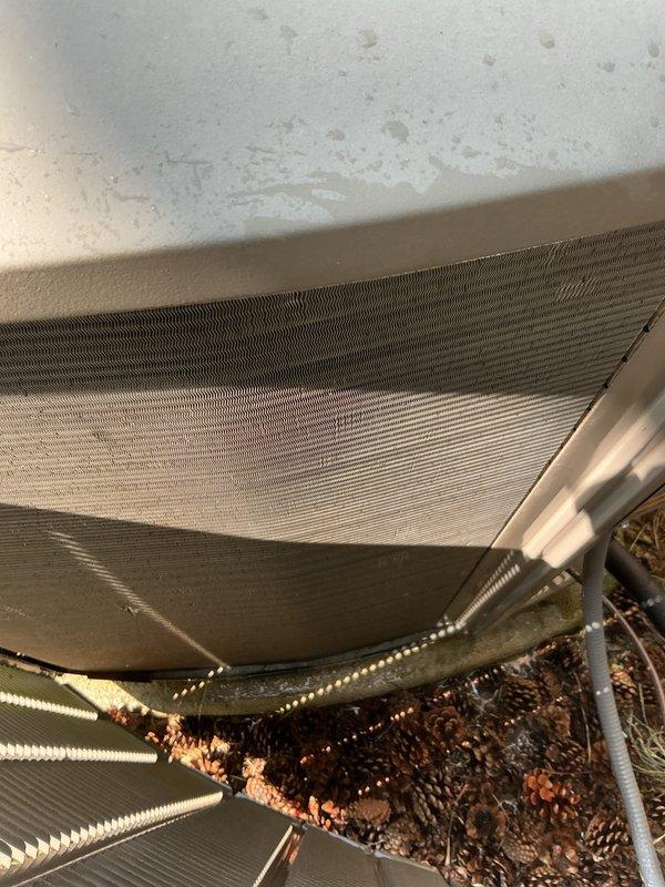 Completed comprehensive AC tune-up service on residential Lennox condensing unit as part of membership renewal. Performed standard preventive maintenance including system inspection, operational testing, and documentation of equipment condition. Notable findings include significant rust-colored oxidation and debris accumulation on lower evaporator coil fins requiring attention, while outdoor condensing unit and associated components remain in operational condition with normal weathering for age.