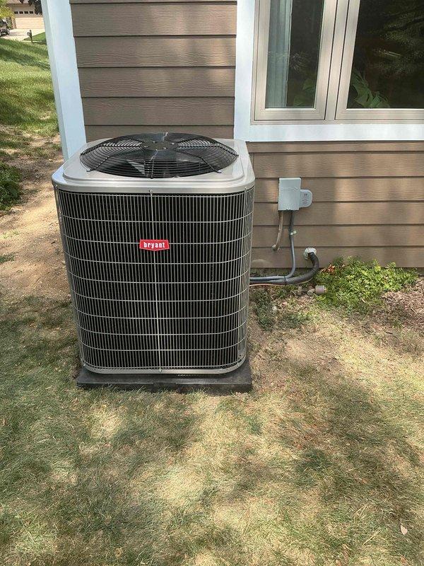 Completed installation of new outdoor air conditioning condenser unit on prepared base pad adjacent to residential structure. Installed refrigerant line set and electrical conduit from outdoor unit through exterior wall, securing all connections to manufacturer specifications and ensuring proper system integration with indoor coil component.