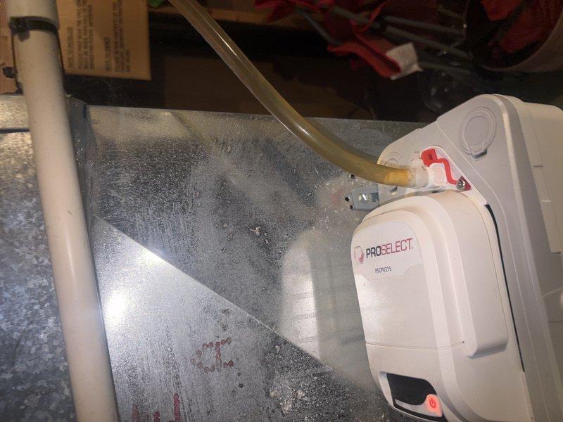 Responded to cooling complaint at new residence where system was blowing cool air but not reaching desired temperature. Inspected attic-mounted air handler and found excessive condensation on unit casing, indicating potential airflow restriction or refrigerant issue. Verified condensate pump operation and drainage system functionality. Checked electrical panel for proper breaker sizing and circuit integrity to rule out power supply issues affecting system performance.