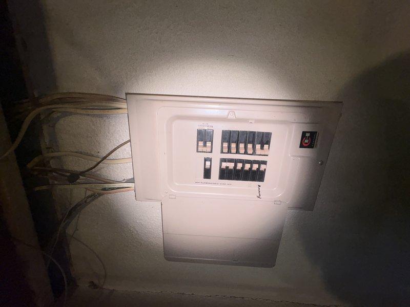 Responded to cooling complaint at new residence where system was blowing cool air but not reaching desired temperature. Inspected attic-mounted air handler and found excessive condensation on unit casing, indicating potential airflow restriction or refrigerant issue. Verified condensate pump operation and drainage system functionality. Checked electrical panel for proper breaker sizing and circuit integrity to rule out power supply issues affecting system performance.