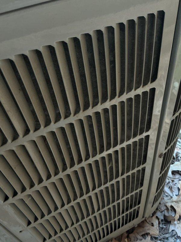 Completed preventive maintenance tune-up on 2017 outdoor air conditioning unit. Performed standard inspection and cleaning procedures, documented unit condition with photographs showing accumulated debris around base and dust buildup on louvered grilles. Unit reset and returned to normal operation following air quality concerns discussed with homeowner, with agreement to follow up if additional service needed.