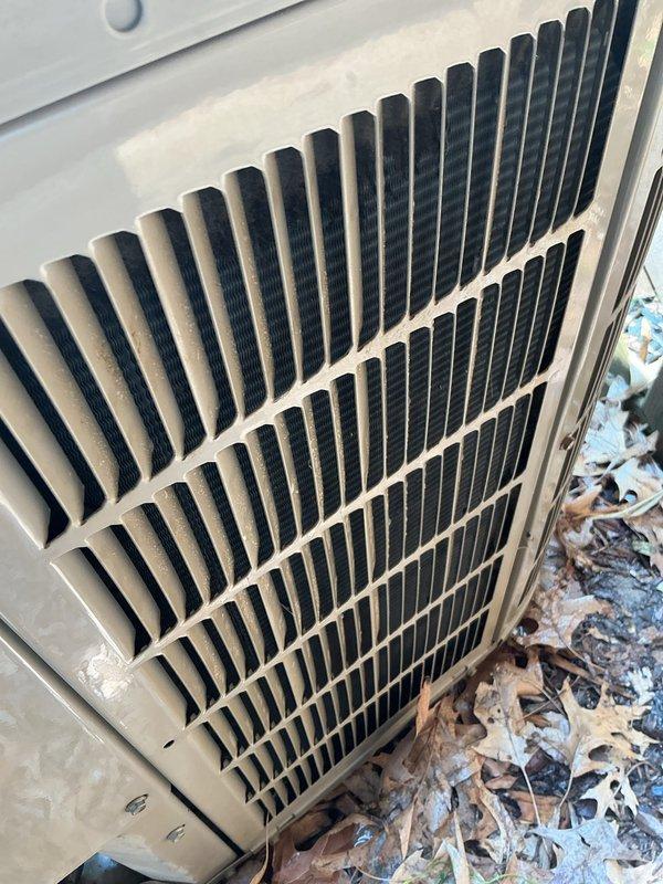 Completed preventive maintenance tune-up on 2017 outdoor air conditioning unit. Performed standard inspection and cleaning procedures, documented unit condition with photographs showing accumulated debris around base and dust buildup on louvered grilles. Unit reset and returned to normal operation following air quality concerns discussed with homeowner, with agreement to follow up if additional service needed.