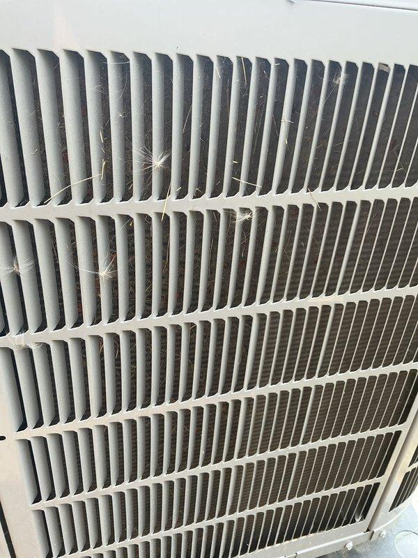 Responded to service call for air conditioning system reset due to poor air quality concerns. Upon arrival, performed thorough inspection of outdoor condenser unit and discovered significant accumulation of debris, cobwebs, and dust throughout the finned coils and protective grille. Cleaned and serviced the condenser coils to restore proper airflow and heat exchange efficiency. Inspected indoor air filtration system and confirmed filter was in clean, operational condition. System tested and verified to be cooling properly after maintenance was completed. Unit returned to normal operation with improved air quality performance.