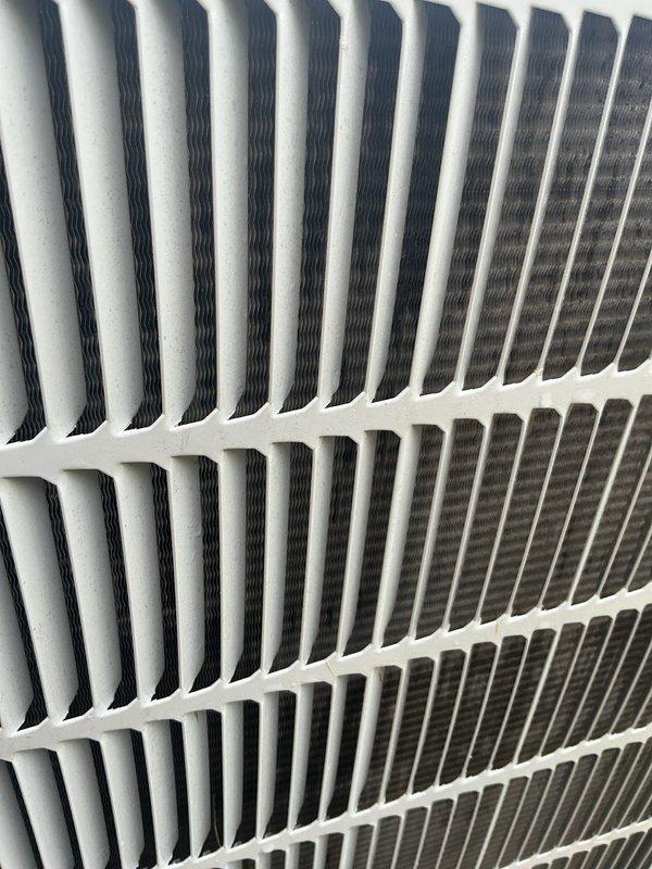 Responded to service call for air conditioning system reset due to poor air quality concerns. Upon arrival, performed thorough inspection of outdoor condenser unit and discovered significant accumulation of debris, cobwebs, and dust throughout the finned coils and protective grille. Cleaned and serviced the condenser coils to restore proper airflow and heat exchange efficiency. Inspected indoor air filtration system and confirmed filter was in clean, operational condition. System tested and verified to be cooling properly after maintenance was completed. Unit returned to normal operation with improved air quality performance.