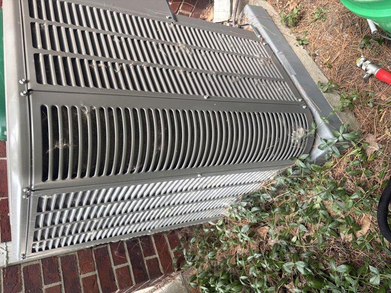 Responded to service call for Bryant air conditioning unit reported to be operating improperly with suspected low refrigerant charge. Upon arrival, performed visual inspection of outdoor condensing unit and documented equipment condition with photographs. Unit appeared operational with accessible condenser coils visible through top grille, though surrounding area showed minimal maintenance with vegetation growth near base. Completed diagnostic assessment of system performance and refrigerant levels to determine necessary repairs.