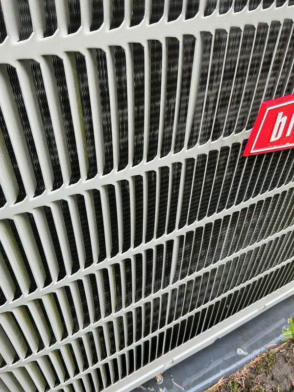 Completed scheduled air conditioning tune-up on Bryant outdoor condensing unit. Performed comprehensive system inspection, cleaned condenser coils showing algae and pollen accumulation on fins, verified proper fan operation and airflow, and confirmed unit returned to optimal cooling performance.