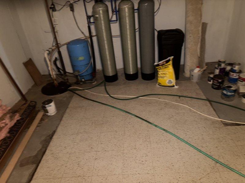 Responded to service call for air conditioning system not maintaining setpoint temperature, with indoor temperature reading 6 degrees above thermostat setting. Performed diagnostic evaluation of HVAC system and associated components in basement mechanical area. Documented existing conditions of water treatment equipment, ductwork, and utility room layout for service records.