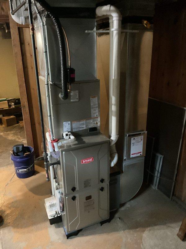 Completed full HVAC system installation in residential basement, including new Bryant furnace and heat pump system. Installed all required PVC venting pipes, flexible ductwork connections, and electrical components per manufacturer specifications. All equipment mounted securely to structural framing, system tested and operational.