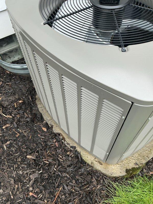 Performed comprehensive air conditioning tune-up on outdoor condensing unit. Upon arrival, noted significant dirt and debris accumulation on condenser coil and internal components visible through side ventilation panels. Completed full system inspection, cleaned condenser coils, checked refrigerant pressures, tested electrical components, verified proper fan operation, and ensured unit was operating within manufacturer specifications. System restored to optimal cooling performance with improved airflow efficiency following maintenance procedures.