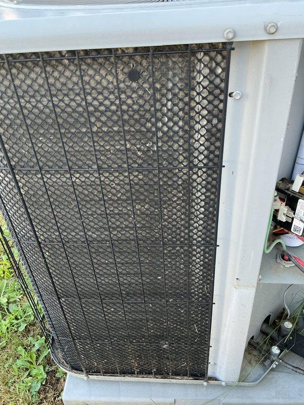 Performed comprehensive gas furnace tune-up and system evaluation for new customer at mobile home residence. Upon arrival, accessed outdoor HVAC unit and documented pre-service condition showing significant dirt and debris accumulation on condenser coil protective grille and exterior surfaces. The diamond-pattern mesh screen exhibited heavy particulate buildup that was restricting airflow through the condenser unit. Completed full preventative maintenance protocol including inspection of all accessible components, cleaning of condenser coils and protective grilles, verification of proper system operation, and documentation of unit condition through photographic records. System returned to normal operating parameters following service completion.