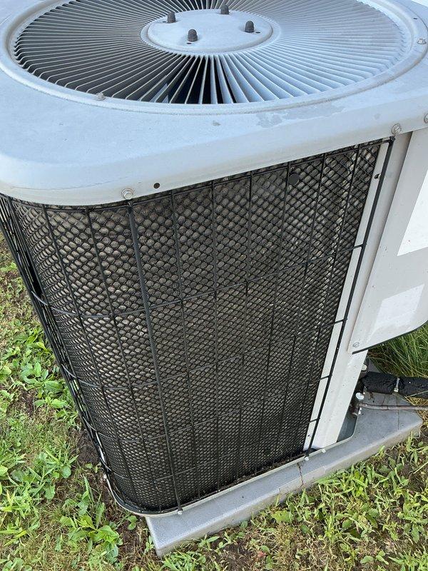 Performed comprehensive gas furnace tune-up and system evaluation for new customer at mobile home residence. Upon arrival, accessed outdoor HVAC unit and documented pre-service condition showing significant dirt and debris accumulation on condenser coil protective grille and exterior surfaces. The diamond-pattern mesh screen exhibited heavy particulate buildup that was restricting airflow through the condenser unit. Completed full preventative maintenance protocol including inspection of all accessible components, cleaning of condenser coils and protective grilles, verification of proper system operation, and documentation of unit condition through photographic records. System returned to normal operating parameters following service completion.