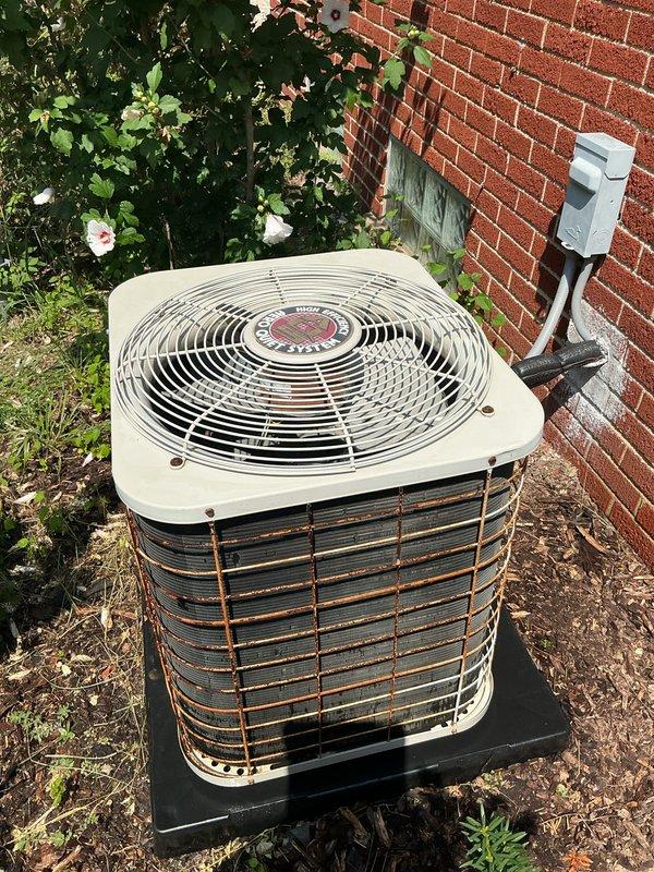 Completed comprehensive air conditioning tune-up on outdoor condensing unit. Performed standard preventive maintenance inspection including checking refrigerant levels, cleaning condenser coils, testing electrical connections at disconnect box, verifying proper fan operation, and inspecting overall unit condition. Unit showed signs of age with rust formation on exterior louvers and grilles, but all mechanical components functioned within normal operating parameters upon completion of service.