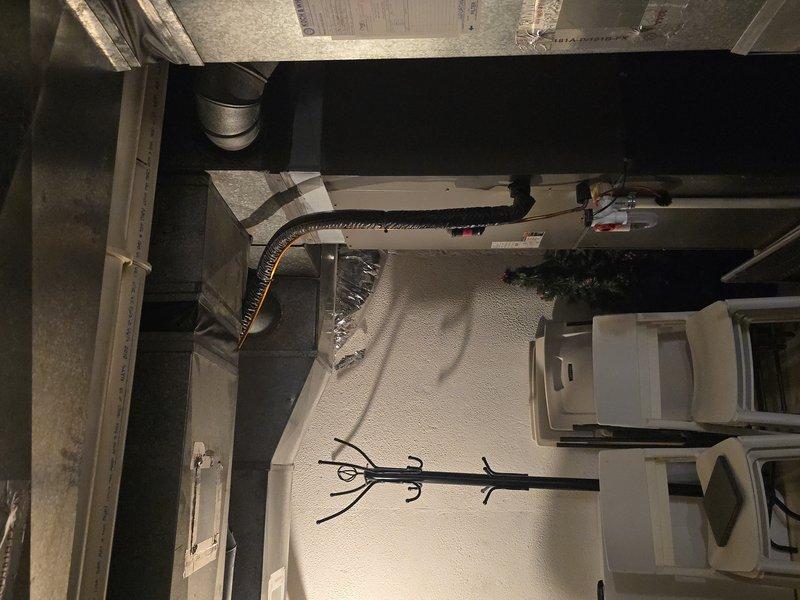 Responded to service call for frozen evaporator coil. Upon arrival, accessed HVAC system in basement utility area and confirmed heavy frost accumulation on evaporator coil and connected ductwork. Customer had previously shut down cooling system and switched to fan-only mode, allowing coil to begin thawing. Performed comprehensive system inspection and cleaning service, documenting conditions with photographic evidence showing extensive ice buildup on refrigerant lines and air handler components. Verified customer had recently replaced air filter prior to service visit. System evaluated for proper airflow and refrigerant concerns that contributed to freezing condition.