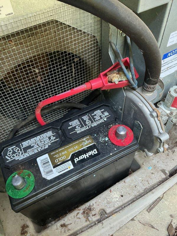 Performed comprehensive air conditioning tune-up and maintenance service. Inspected outdoor condenser unit, which showed good operational condition with clean coils and properly functioning fan assembly. Upon customer request, examined generator battery terminals and confirmed corrosion and wear on both positive and negative connections. Cleaned battery terminals, verified secure cable connections, and tested charging system functionality. Unit operating within normal parameters upon service completion.