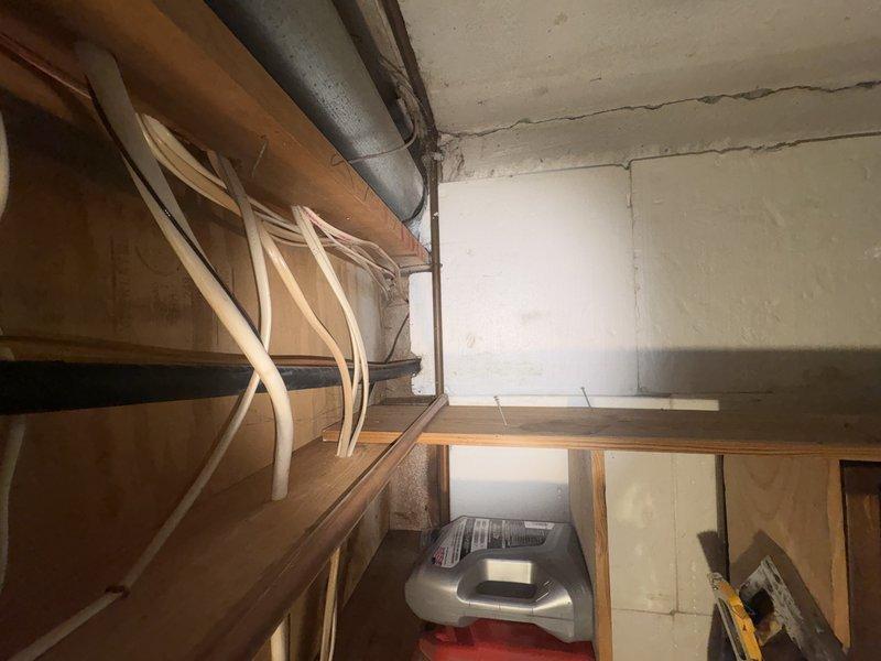 Responded to service call for residential A/C system not cooling properly with suspected low refrigerant charge. Upon arrival, accessed mechanical equipment in basement utility area and performed system diagnostics. Inspected HVAC equipment, ductwork, and associated components in unfinished space with exposed concrete block walls. Evaluated refrigerant levels and system performance to determine root cause of cooling deficiency.