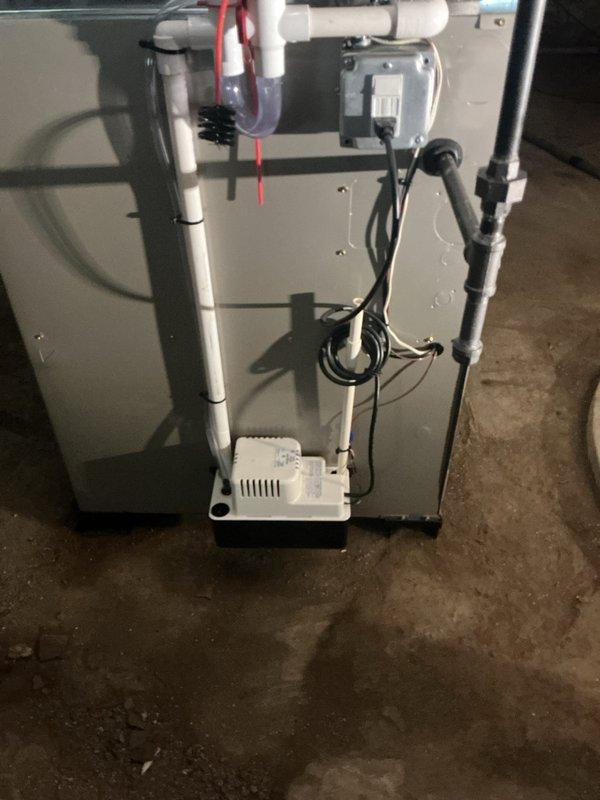 Completed full installation of new Bryant heating and cooling system including indoor air handler and outdoor condensing unit. Installed complete condensate management system with pump, PVC drainage lines, and safety pan with overflow protection, routing discharge piping through exterior wall with proper penetration sealing. All electrical connections, refrigerant lines, and ductwork transitions completed to manufacturer specifications with system tested and operational.