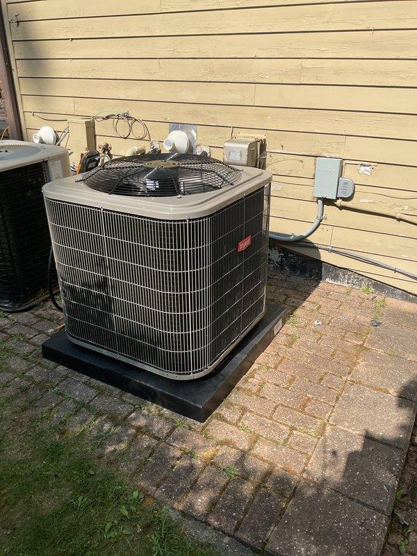 Completed full HVAC system installation including new air conditioning condenser unit, humidification equipment, and ductwork modifications. Installed outdoor condenser unit (Model L31SA0B3620ABAC, Serial 0826C25690) on composite pad against exterior wall with proper clearances, connected refrigerant lines via wall penetration with PVC sleeve protection, and mounted electrical disconnect box with conduit per code requirements. Unit specifications include 208-230V AC power supply with TXU metering configuration. All components secured to horizontal lap siding with appropriate mounting hardware, system tested and operational.