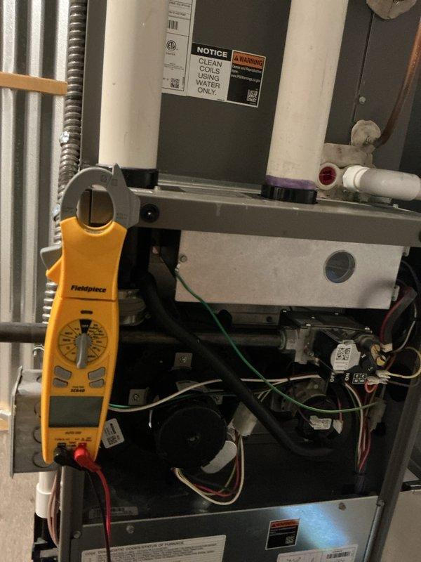 Performed comprehensive tune-up maintenance on multi-zone HVAC system serving attic and ground floor units. Conducted electrical diagnostics using clamp meter to verify proper amperage draw and system performance, inspected and evaluated evaporator coils per manufacturer specifications, and cleared drainage system including P-trap assembly which showed evidence of biological buildup requiring cleaning to ensure proper condensate flow and prevent future blockages.