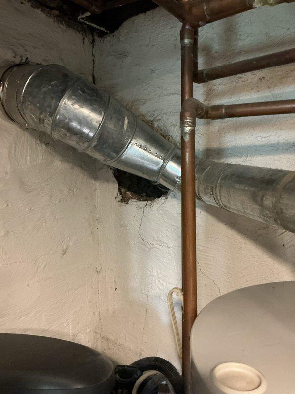 Completed installation of a new tanked water heater in basement utility area. Removed existing unit and installed replacement water heater with proper connections to existing copper supply lines and drainage system. Installed blue expansion tank on wall and connected to plumbing network to accommodate thermal expansion and protect system integrity. Verified all connections for proper operation, tested temperature and pressure relief valve functionality, and ensured compliance with manufacturer specifications and local plumbing codes. System tested and confirmed operational with no leaks detected.