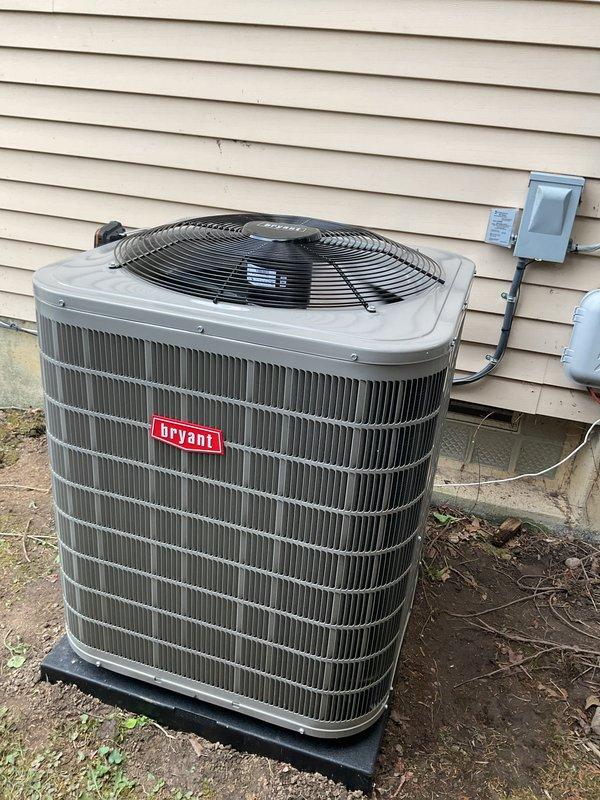Completed full HVAC system installation including gas furnace, central air conditioning condenser unit, and whole-home humidifier in residential basement mechanical room. Installed Bryant brand outdoor condensing unit on composite pad against exterior foundation with proper clearances, mounted electrical disconnect box on exterior siding, and ran refrigerant line set and electrical conduit from disconnect to unit. Interior installation included vertical gas furnace with supply and return ductwork connections, integrated humidifier system, and all necessary electrical wiring and control connections. All equipment properly vented, leveled, and tested for operation. System commissioned and verified for proper airflow, refrigerant charge, and humidity control functionality.