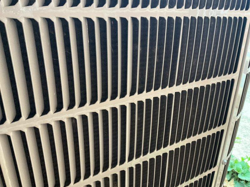 Completed scheduled AC tune-up and preventative maintenance on outdoor condensing unit. Inspected exterior grille, coil fins, and housing components; noted debris accumulation on top grille requiring attention during routine maintenance. System operational and cooling properly upon completion of service visit.