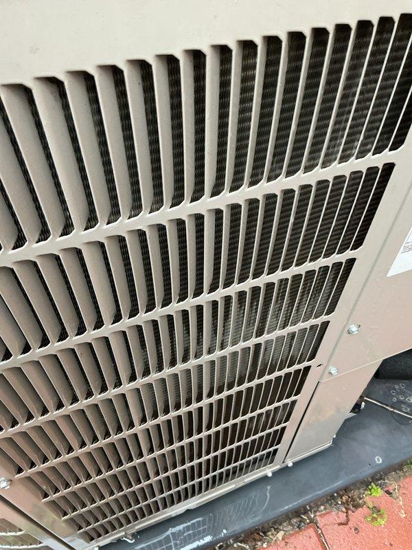 Completed scheduled AC tune-up and preventative maintenance on outdoor condensing unit. Inspected exterior grille, coil fins, and housing components; noted debris accumulation on top grille requiring attention during routine maintenance. System operational and cooling properly upon completion of service visit.