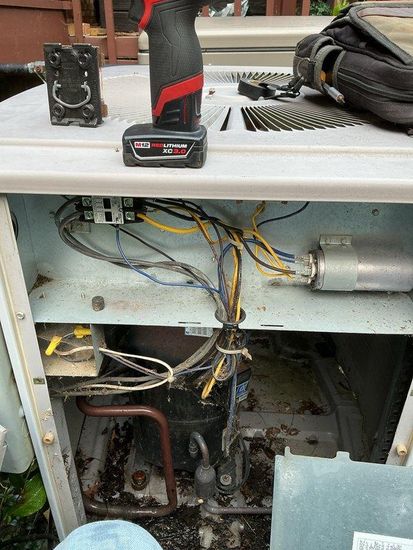 Completed comprehensive AC tune-up on outdoor condensing unit as part of prepaid maintenance agreement. Performed standard preventive maintenance procedures including inspection of electrical components, capacitor testing, refrigerant line examination, and cleaning of internal compartment. Noted moderate corrosion and staining in lower compartment area with accumulated debris on interior surfaces and around pipe fittings, though unit remains operational at this time.
