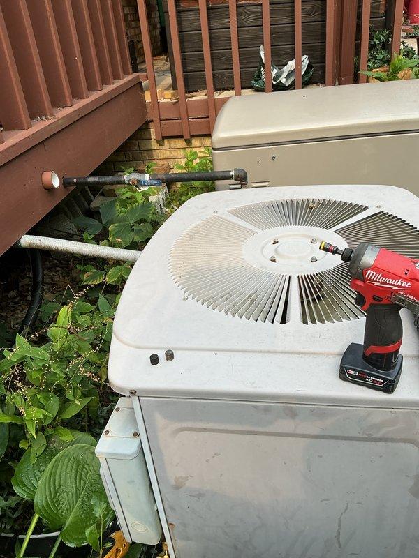 Completed comprehensive AC tune-up on outdoor condensing unit as part of prepaid maintenance agreement. Performed standard preventive maintenance procedures including inspection of electrical components, capacitor testing, refrigerant line examination, and cleaning of internal compartment. Noted moderate corrosion and staining in lower compartment area with accumulated debris on interior surfaces and around pipe fittings, though unit remains operational at this time.