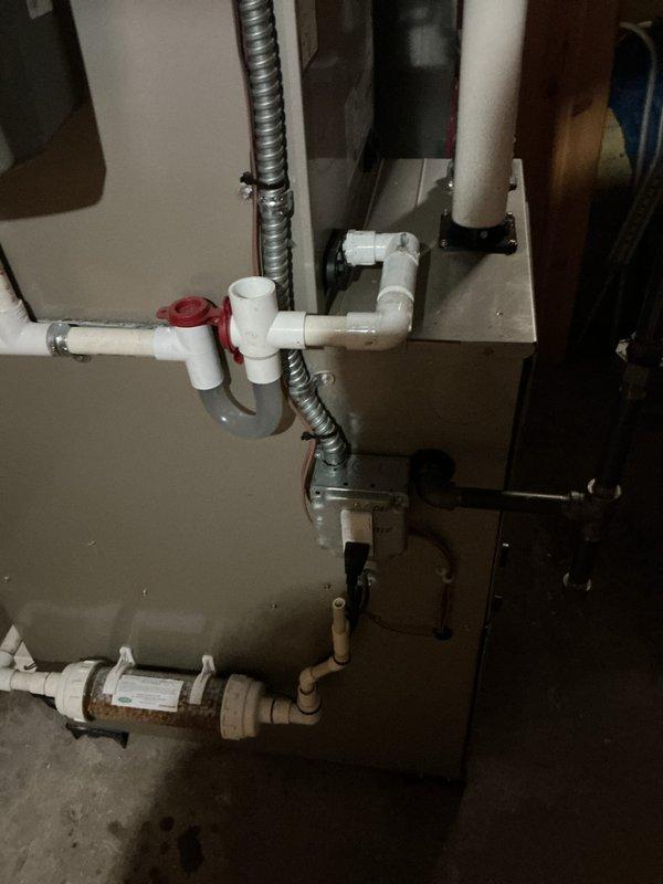 Completed routine gas furnace tune-up and maintenance inspection. System operational with proper drainage configuration observed through PVC piping network and condensate removal components. Unit serviced and ready for upcoming heating season.