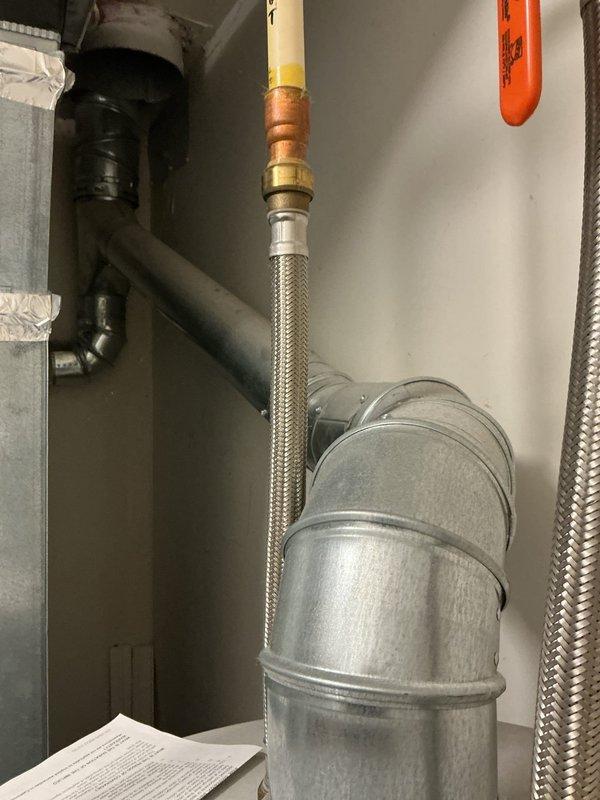 Responded to service call for water heater evaluation with customer concern regarding potential anode rod replacement. Upon arrival, performed comprehensive inspection of tanked water heater unit and associated plumbing connections. Examined water heater condition, including assessment of anode rod status, temperature and pressure relief valve, gas line connections, and overall unit performance. Inspected flexible braided gas supply line with brass fittings, verified proper connections and absence of leaks. Evaluated galvanized ductwork for exhaust venting system, noting proper installation and clearances. Documented existing conditions through photographic evidence showing mechanical room layout, water heater installation, gas line routing, and ventilation components. Observed evidence of potential moisture concerns near ceiling-mounted ductwork connections with visible staining. Provided customer with detailed findings and recommendations for necessary repairs or replacements based o