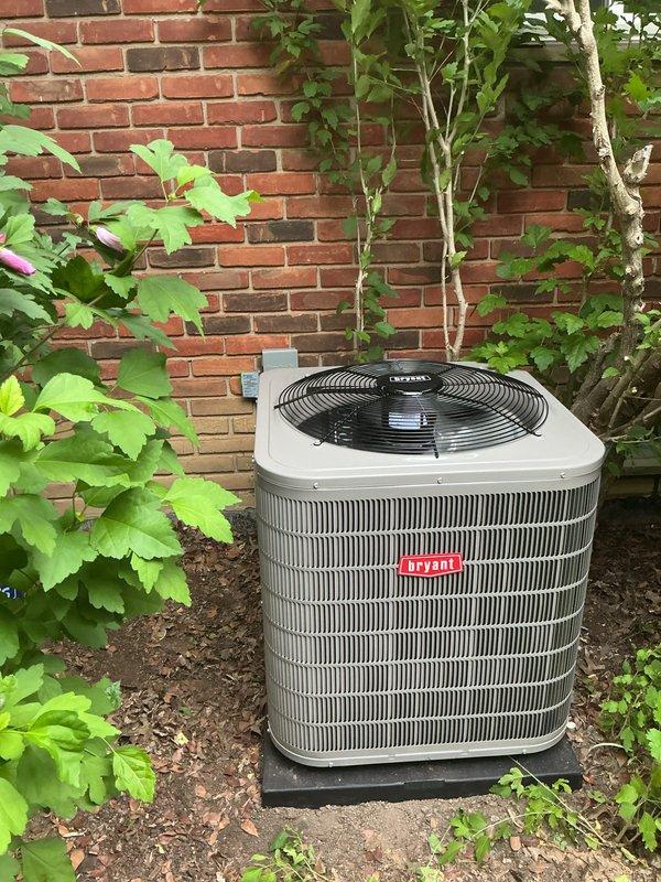 Completed installation of Bryant air conditioning condenser unit at residential property. Unit was positioned on rubber isolation pad against exterior brick wall, with proper clearance for airflow and service access. Connected refrigerant lines to indoor evaporator coil, evacuated system, and charged to manufacturer specifications. Verified electrical connections, tested unit operation, and confirmed proper fan function and cooling cycle. System is operating within normal parameters.