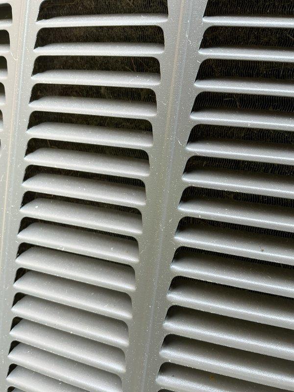 Performed comprehensive AC tune-up and cleaning service on Trane condensing unit with no reported issues. Completed thorough inspection of outdoor unit, cleaned condenser coils to remove debris and restore optimal heat transfer efficiency, and verified proper operation of all components including fan motor and electrical connections. Unit photographed showing cleaned coil fins and overall system condition, with equipment found to be in good working order and properly maintained.