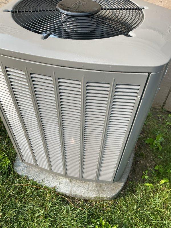 Performed comprehensive AC tune-up and cleaning service on Trane condensing unit with no reported issues. Completed thorough inspection of outdoor unit, cleaned condenser coils to remove debris and restore optimal heat transfer efficiency, and verified proper operation of all components including fan motor and electrical connections. Unit photographed showing cleaned coil fins and overall system condition, with equipment found to be in good working order and properly maintained.