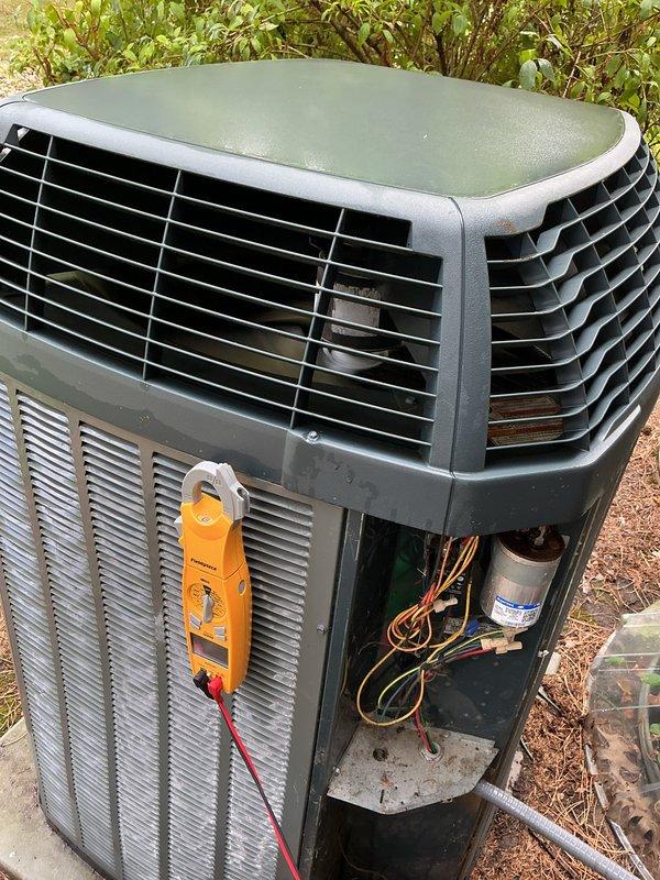 Completed scheduled AC tune-up and preventative maintenance on outdoor condensing unit. Performed electrical diagnostics using multimeter, measuring amperage draw at 82.5 amps to verify compressor operation within manufacturer specifications. Inspected internal components including refrigerant lines, electrical connections, and capacitor. System tested and confirmed operating properly in cooling mode.