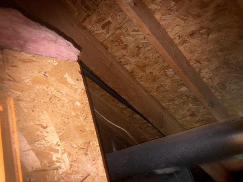 Responded to service call for older AC unit not cooling upstairs living space. Performed diagnostic inspection of attic-mounted HVAC system, accessing unit through attic crawlspace. Conducted visual assessment of ductwork, insulation integrity, and equipment condition. Documented attic installation with photos showing OSB decking, pink fiberglass insulation, structural framing, and horizontal duct runs. Collected standard service fee and presented repair options to address cooling deficiency. Overtime service was offered but declined.