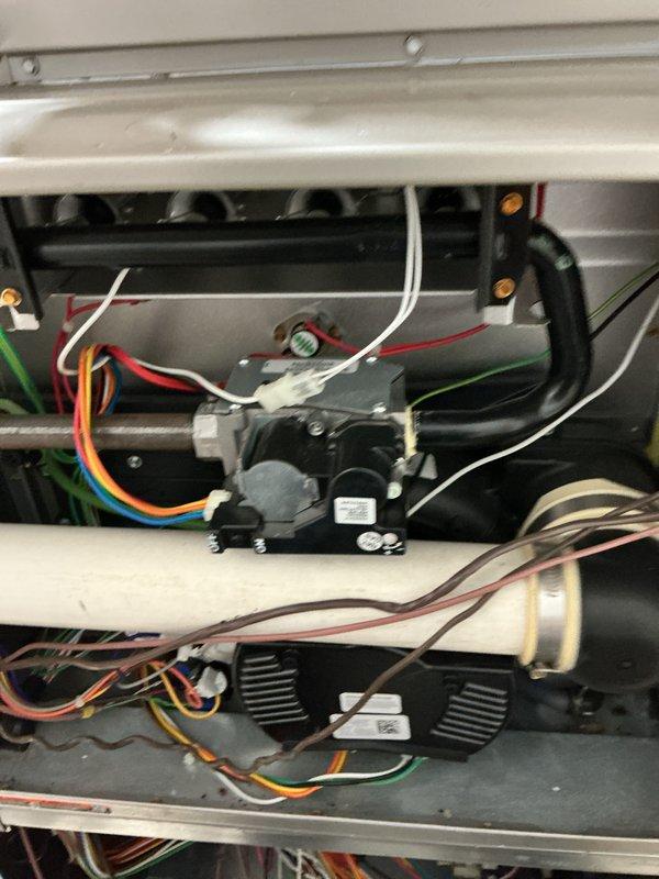Completed recurring maintenance service on ground floor HVAC system and tankless water heater unit. Performed comprehensive inspection of internal components including contactors, relays, and electrical connections. Verified proper operation of dual fan motor assemblies, checked all wiring connections for secure attachment and proper insulation, and inspected refrigerant lines and condensate drainage system. All components found to be functioning within normal operating parameters. System returned to full operational status.