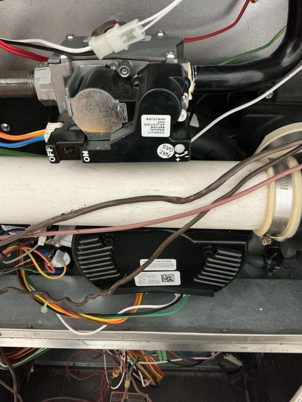 Completed recurring maintenance service on ground floor HVAC system and tankless water heater unit. Performed comprehensive inspection of internal components including contactors, relays, and electrical connections. Verified proper operation of dual fan motor assemblies, checked all wiring connections for secure attachment and proper insulation, and inspected refrigerant lines and condensate drainage system. All components found to be functioning within normal operating parameters. System returned to full operational status.