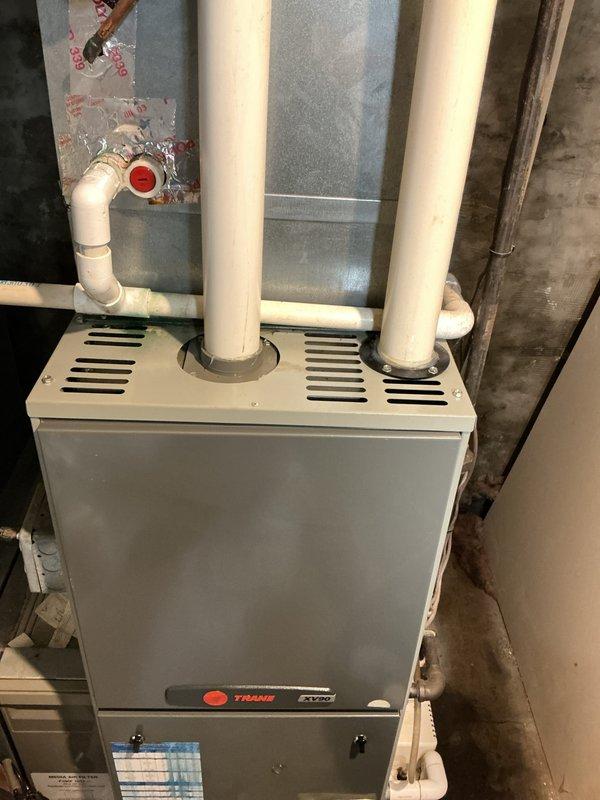 Completed comprehensive AC tune-up and preventative maintenance inspection on residential Trane HVAC system that had not been serviced in five years. Performed full system diagnostic including electrical testing with multimeter, inspected burner assembly, gas valves, inducer motor, blower components, and all control modules for proper operation. Verified all electrical connections, examined PVC intake and exhaust venting for proper installation, and confirmed system is operating within manufacturer specifications with no issues detected.