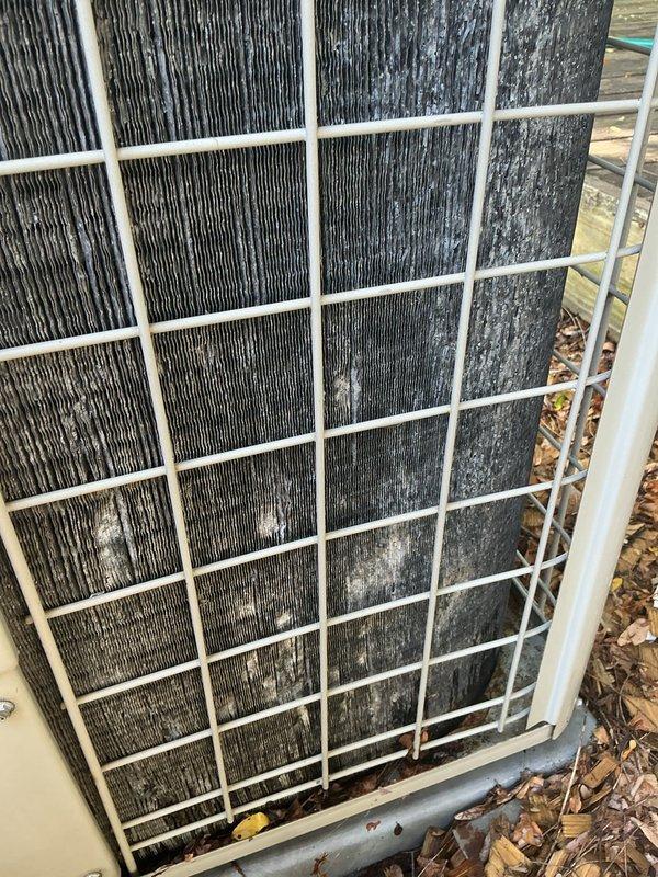 Completed scheduled preventive maintenance on residential air conditioning system. Performed thorough inspection of outdoor condenser unit, which revealed heavily contaminated condenser coils with significant dirt, debris, and organic matter accumulation affecting heat transfer efficiency. Cleaned condenser coils and removed accumulated leaves and debris from base of unit and surrounding area. Inspected electrical components, contactors, and wiring connections inside condenser cabinet. Verified system operation and confirmed unit returned to proper cooling function. Discussed potential thermostat upgrade options with customer for future consideration.