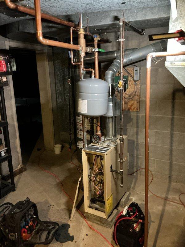 Completed comprehensive AC tune-up and maintenance service on multi-zone ductless mini-split system with two indoor head units. Performed standard preventative maintenance procedures including filter inspection and cleaning, coil evaluation, condensate drain verification, and refrigerant pressure checks. Inspected basement mechanical room housing boiler system, water heater, and associated copper piping infrastructure. All equipment found operating within normal parameters with no deficiencies noted. System tested and confirmed functioning properly upon completion of service.