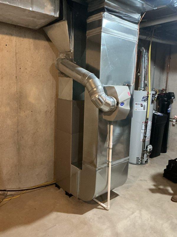 Completed full installation of Bryant heating and cooling system in basement mechanical room. Installed new furnace unit with metallic supply ductwork routing to distribution system, ensuring proper clearances from existing water heater and plumbing infrastructure. Integrated system with homeowner's existing Nest thermostat, maintaining current control interface. All electrical connections completed to code, system tested and operational.