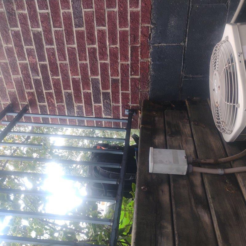 Conducted comprehensive HVAC estimate for complete system replacement at residential property with two existing white condenser units installed against exterior wall. Assessed current dual-unit configuration, including refrigerant line sets, electrical conduit routing, condensate drainage, and mounting provisions on concrete block and brick wall surfaces. Evaluated equipment placement considerations for deck-mounted unit and wall-adjacent installation, documented existing line set conditions with active service gauges attached, and provided detailed recommendations for full system upgrade including proper sizing, placement optimization, and code-compliant installation specifications.