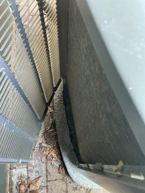 Completed comprehensive AC tune-up and maintenance service on 4-year-old Lennox unit with warranty through July 2027. Inspected condenser coils and found significant accumulation of leaves, organic debris, and dirt lodged between fins and at base of unit. Cleaned condenser coils to restore proper airflow and heat transfer efficiency, removed all debris from unit perimeter and concrete pad. Performed standard preventative maintenance checks including refrigerant line inspection, drainage line verification, and overall system operational testing. System confirmed working properly upon completion with improved airflow through heat exchanger fins.