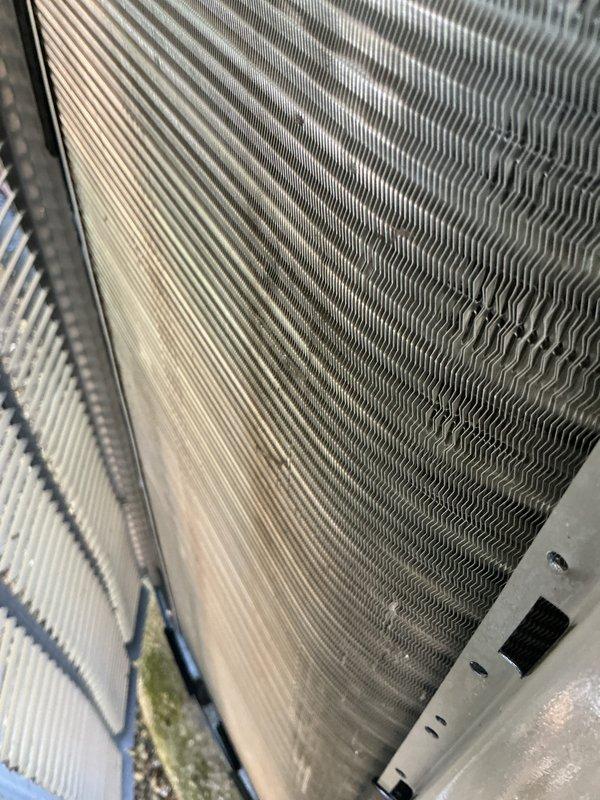 Completed scheduled AC tune-up and preventative maintenance on cooling system. Inspected outdoor condenser unit, finding heavily soiled air filter with significant dust and debris accumulation requiring replacement. Examined evaporator coil and heat exchanger fins, noting some discoloration and residue buildup between fins. System restored to proper cooling operation following maintenance procedures.
