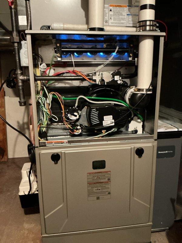 Completed comprehensive tune-up and preventative maintenance on residential multi-zone HVAC system including air conditioning unit and gas furnace. Performed full inspection of gas furnace internal components, verified proper burner ignition and flame characteristics showing optimal blue flame pattern, tested blower motor assembly operation, inspected electrical connections and wiring throughout unit, and confirmed proper venting through PVC intake/exhaust piping. Evaluated heat exchanger condition, control board functionality, and safety mechanisms. Processed membership renewal for continued service coverage.