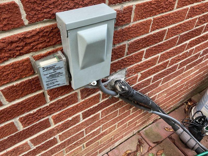 Conducted comprehensive on-site evaluation for complete HVAC system replacement at residential property. Assessed existing outdoor condensing unit located on concrete pad in side yard area, documenting current equipment condition and installation configuration. Evaluated exterior electrical service connection mounted on brick wall, including weatherproofed conduit routing and utility hookup specifications. Documented site conditions including equipment placement, clearances, existing concrete pad foundation, electrical infrastructure, and accessibility for full system replacement installation.