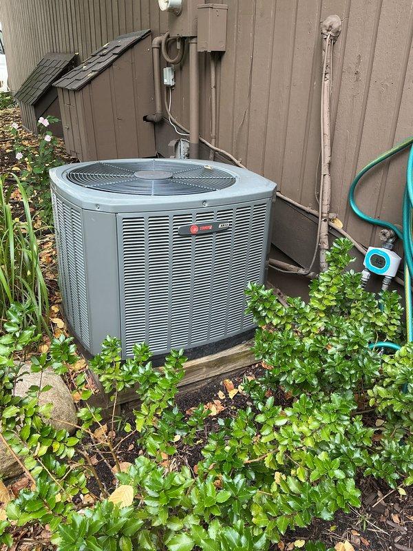 Completed scheduled AC tune-up on Trane outdoor condensing unit. Performed comprehensive preventive maintenance inspection, verified system operation in cooling mode, and documented equipment condition with photos showing unit properly positioned on pad with adequate clearance and vegetation management around perimeter.