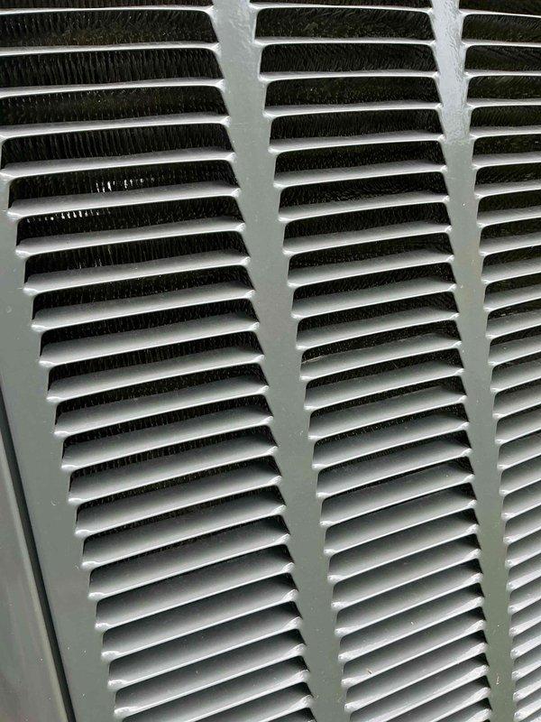 Performed routine maintenance on residential cooling system. Inspected outdoor condenser unit and confirmed operational status, noting minor insulation deterioration at top of unit. Cleaned and evaluated air handler grille, removing dust accumulation from louvers and ventilation openings to ensure proper airflow throughout the system.