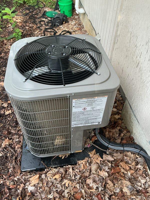 Performed routine maintenance inspection on outdoor air conditioning condenser unit. Unit operational and positioned on concrete pad with proper clearance. Documented current system condition with photos showing beige metal housing, top-mounted fan assembly with protective grille, and refrigerant lines properly routed from unit. Noted accumulation of leaves and organic debris around unit base requiring future attention. Customer requested conversion from monthly payment plan to annual membership billing and scheduling for fall maintenance visit.